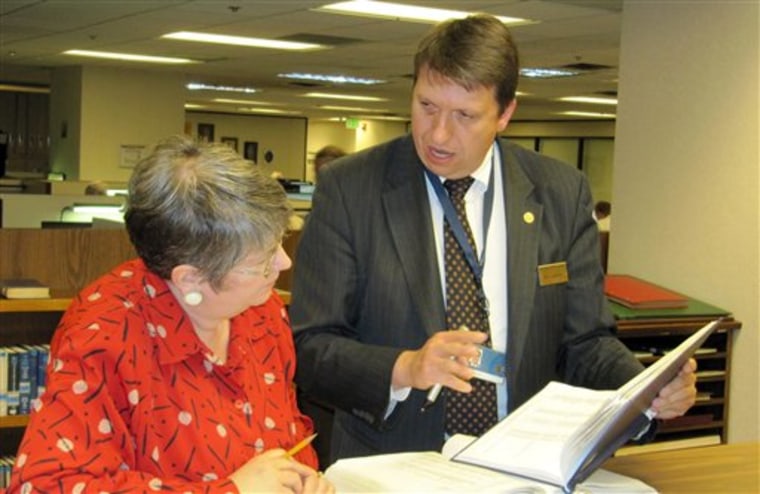 Erin Hunt of Taylorsville, Utah, left, looks through Irish land records with Family History Library staffer Mark Gardner at the Mormon church-owned library in Salt Lake City on  May 4, 2010. 